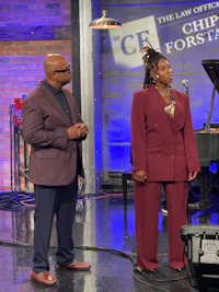 two people standing in front of a microphone